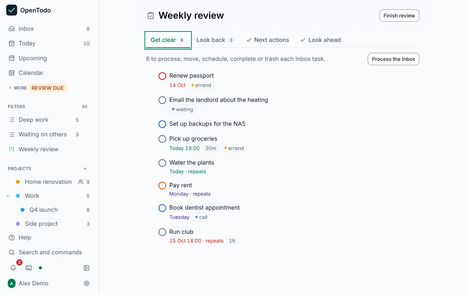 The Weekly review screen on its first step, Get clear: four step tabs with counts, two Inbox tasks, and the Finish review button.